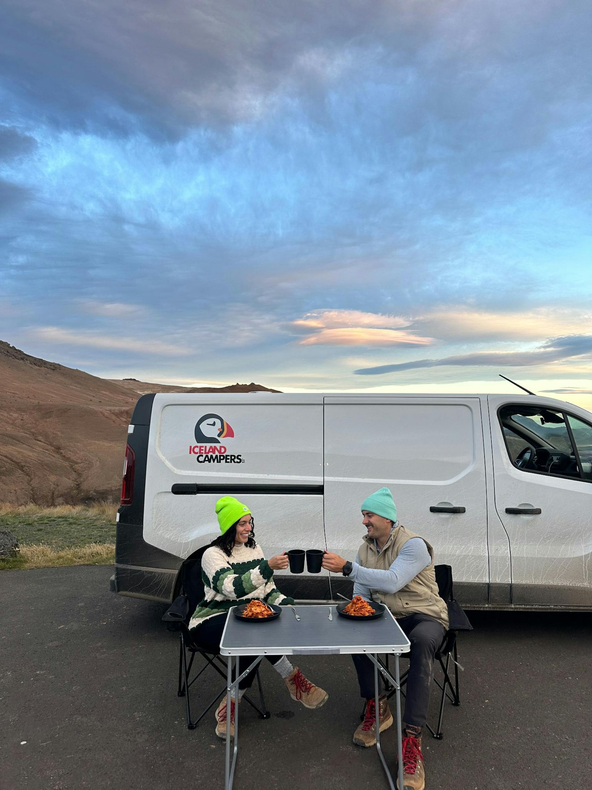 Happy campers enjoying a cozy evening with a delicious outdoor meal.
