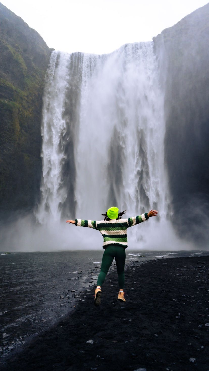 Happy campers admiring a breathtaking Seljalandsfoss waterfall in the wilderness.
