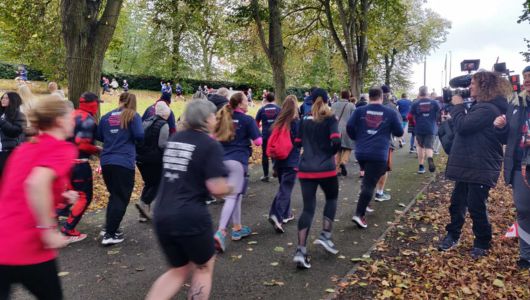  Group of people running away from the camera wearing Terry Fox Run merchandise