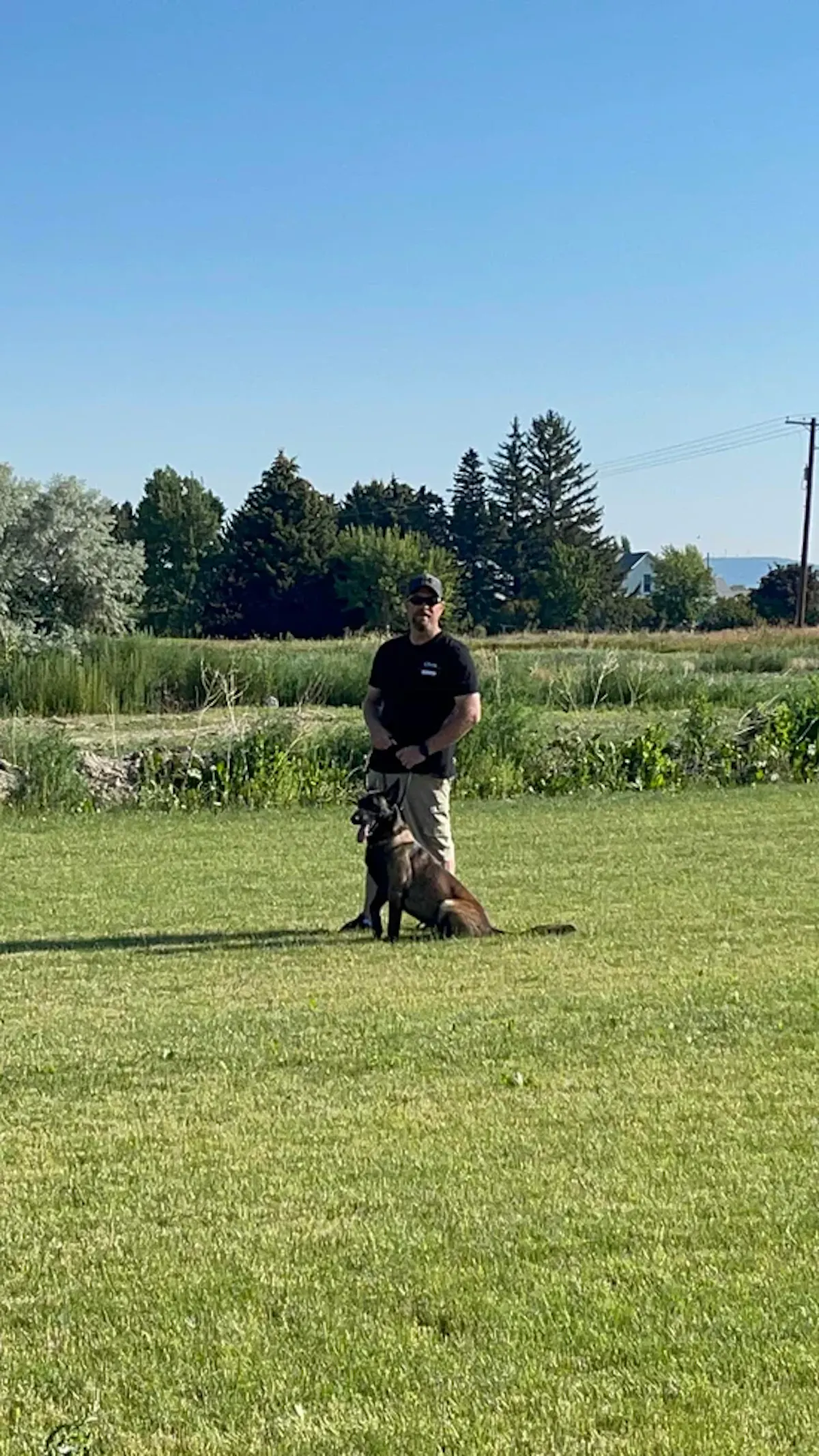 Chris and Tango in a field, training