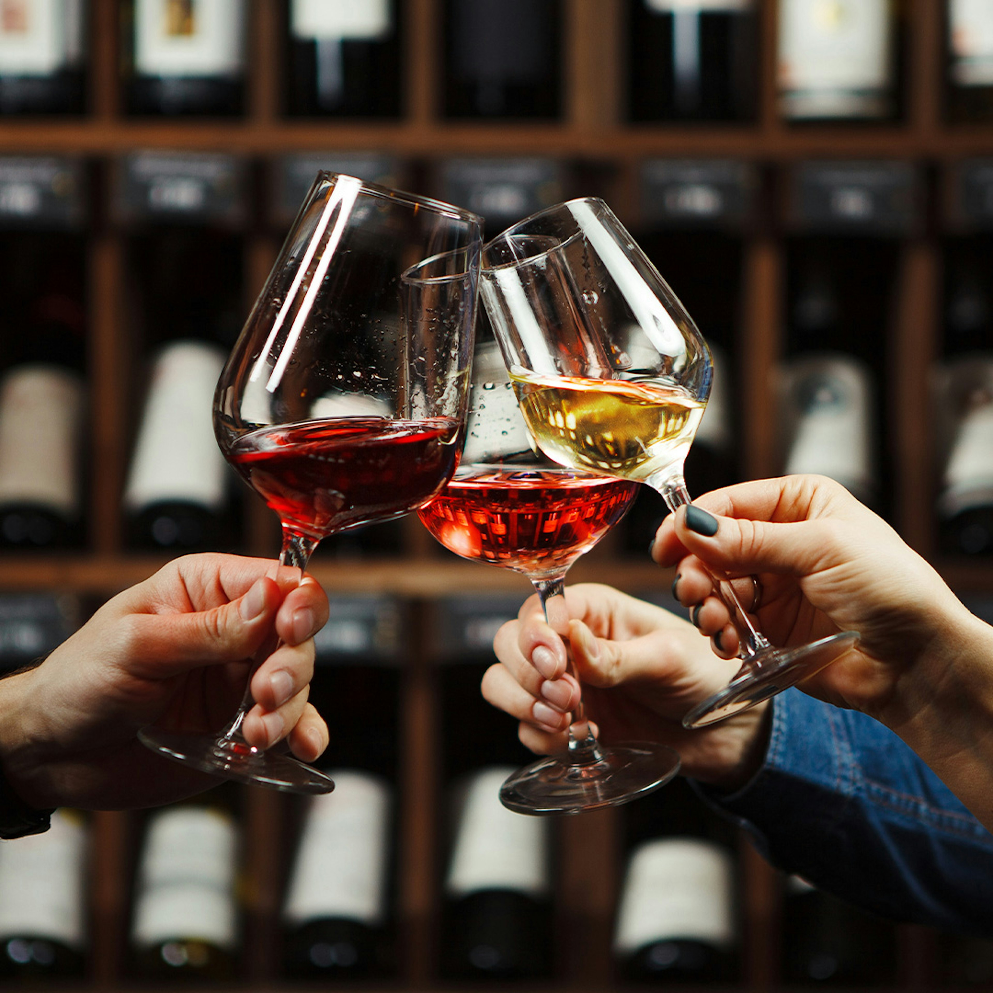 people raising wine glasses in a cheers