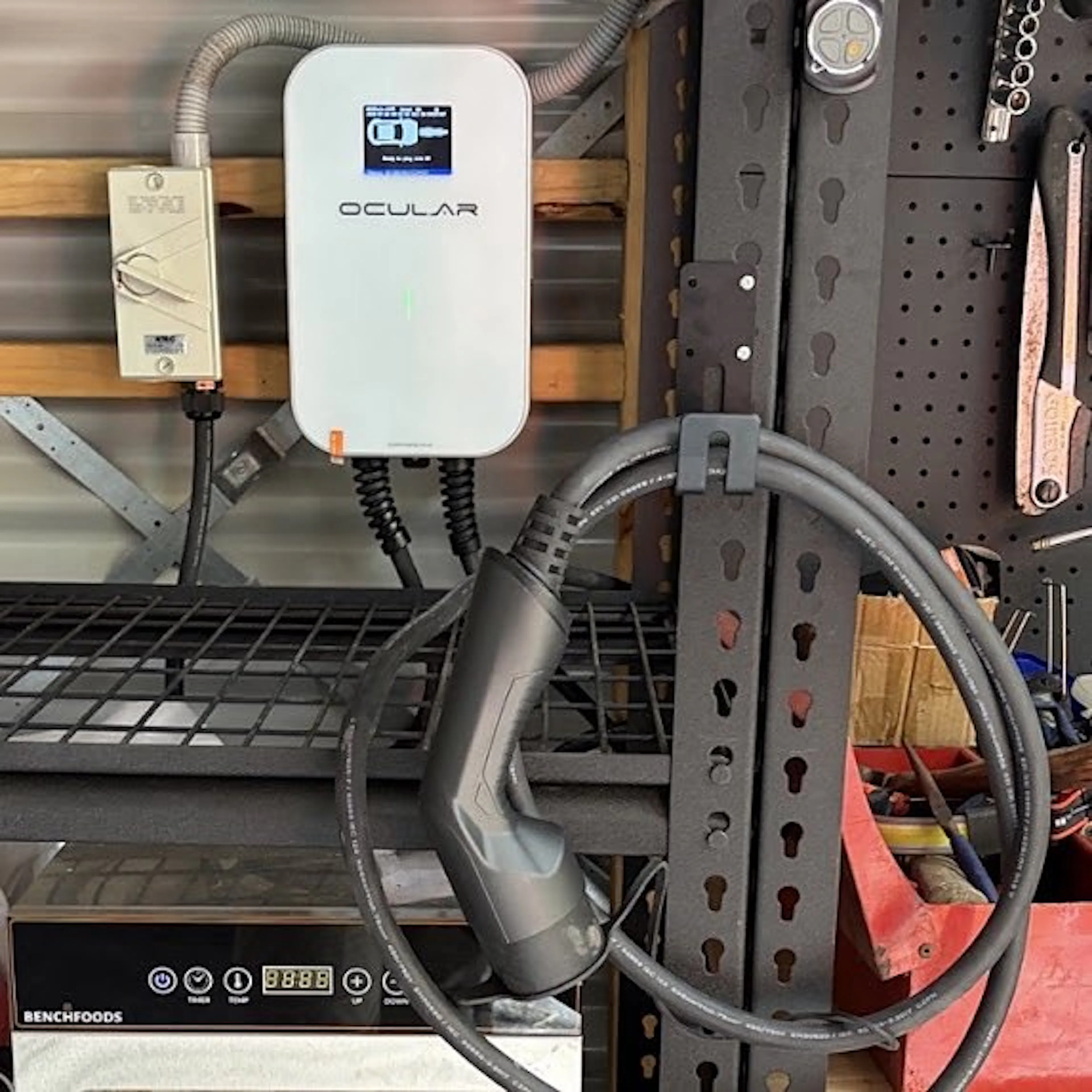 Three phase EV charger with its cable hung on a hook, by Impulse Electrical Enterprise