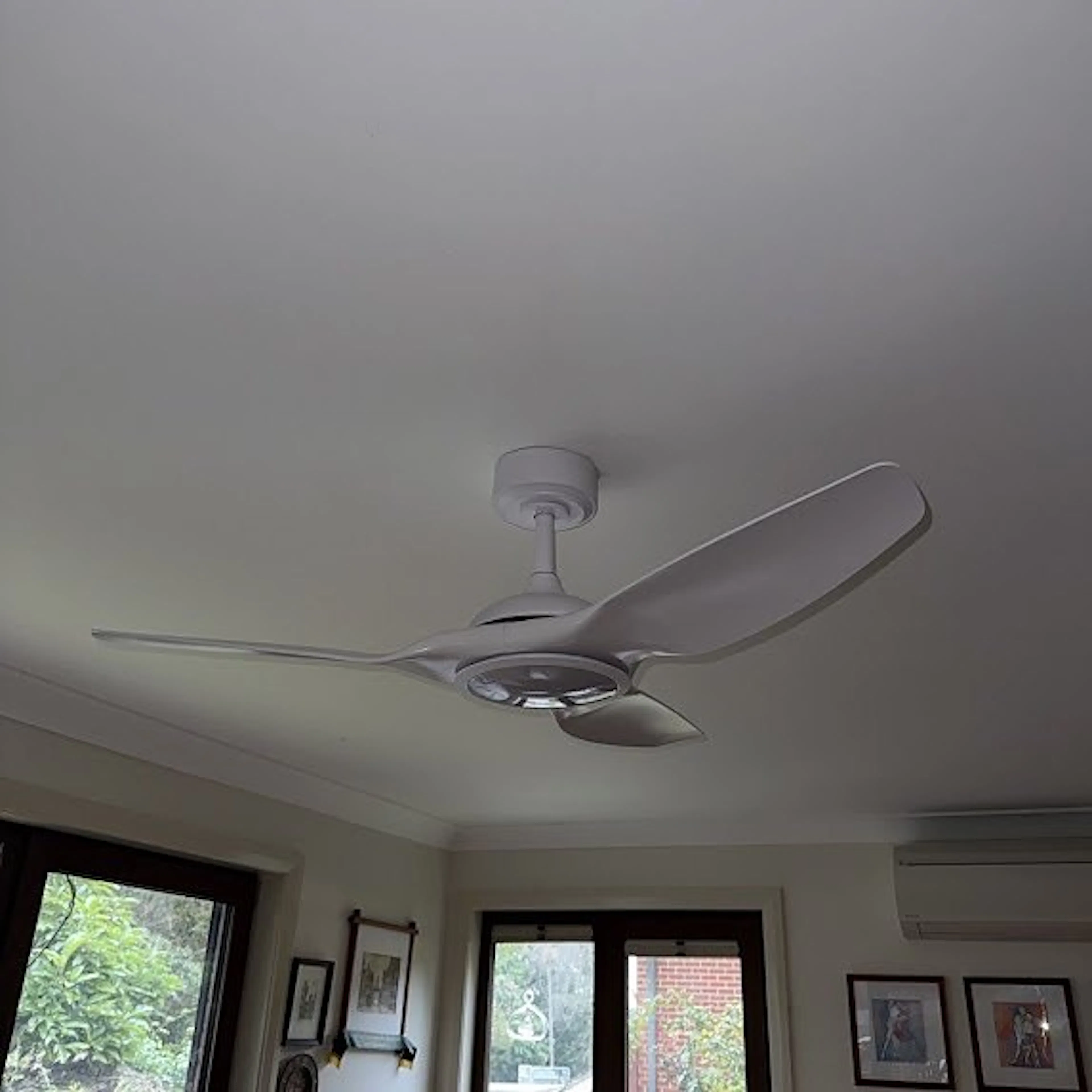 Ceiling fan with a light in a living room, by Impulse Electrical Enterprise