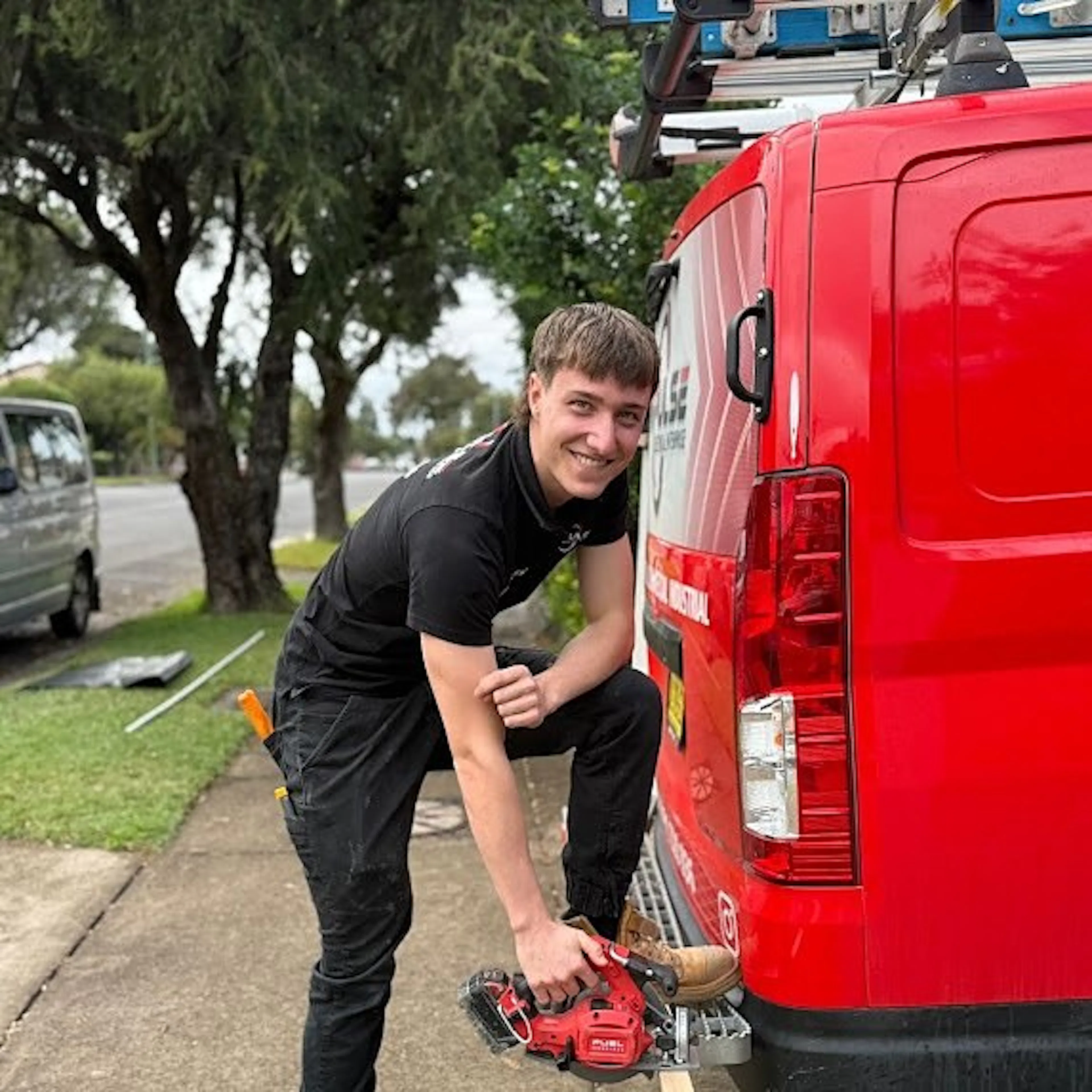 An Impulse Electrical Enterprise electrician with the branded red van