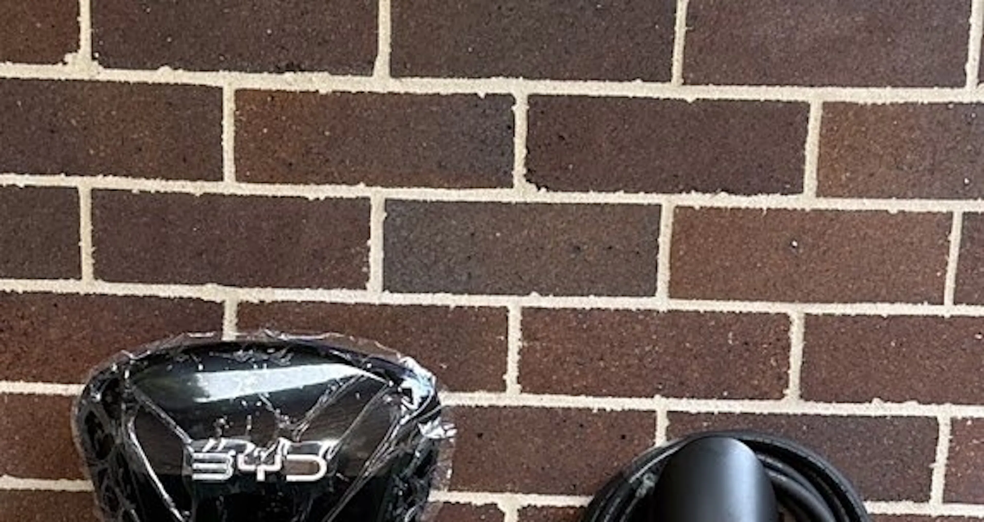 Single phase EV charger and cable holder on a brick wall in Croydon Park, by Impulse Electrical Enterprise