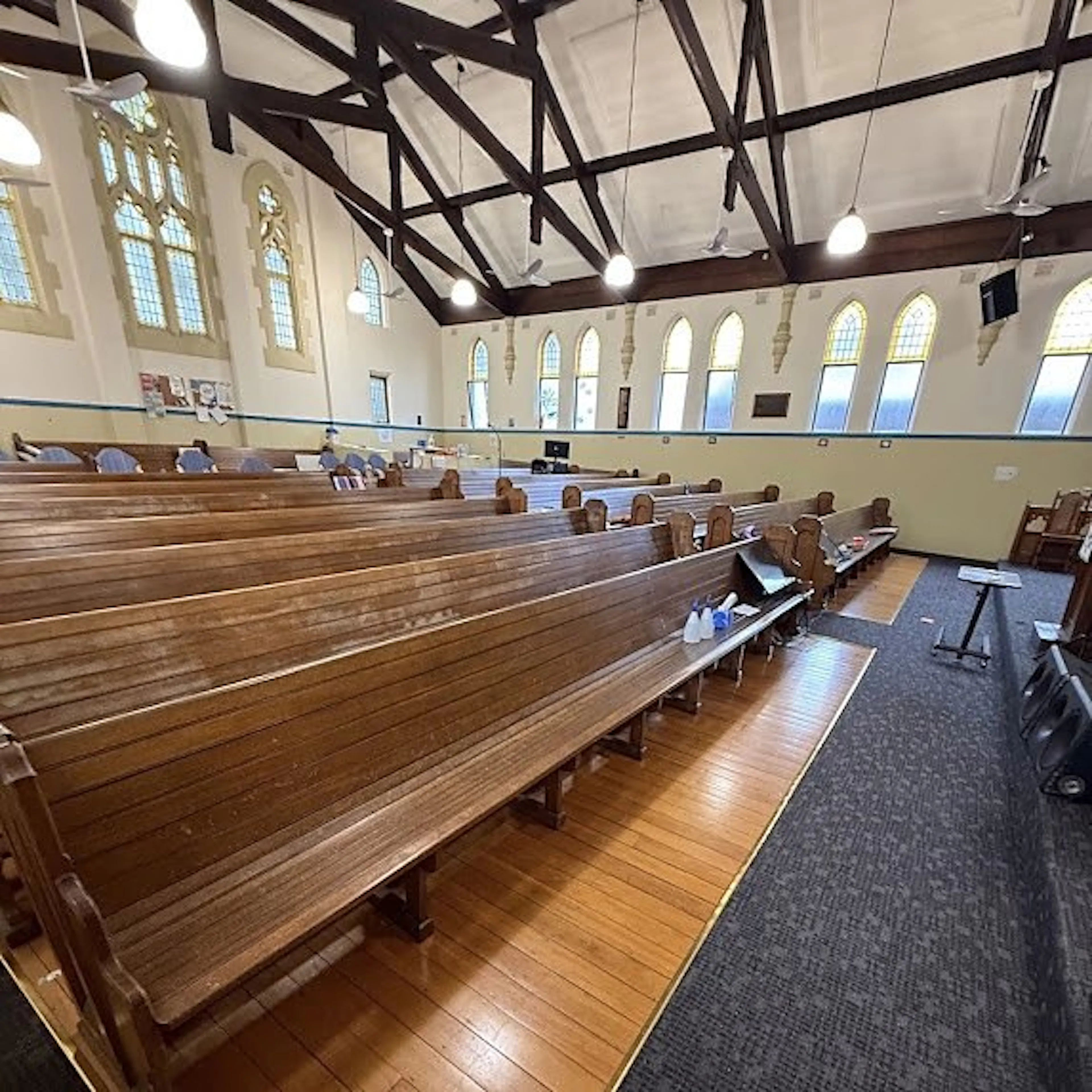 Church hall with ceiling fans and pendant lights above the pews, by Impulse Electrical Enterprise