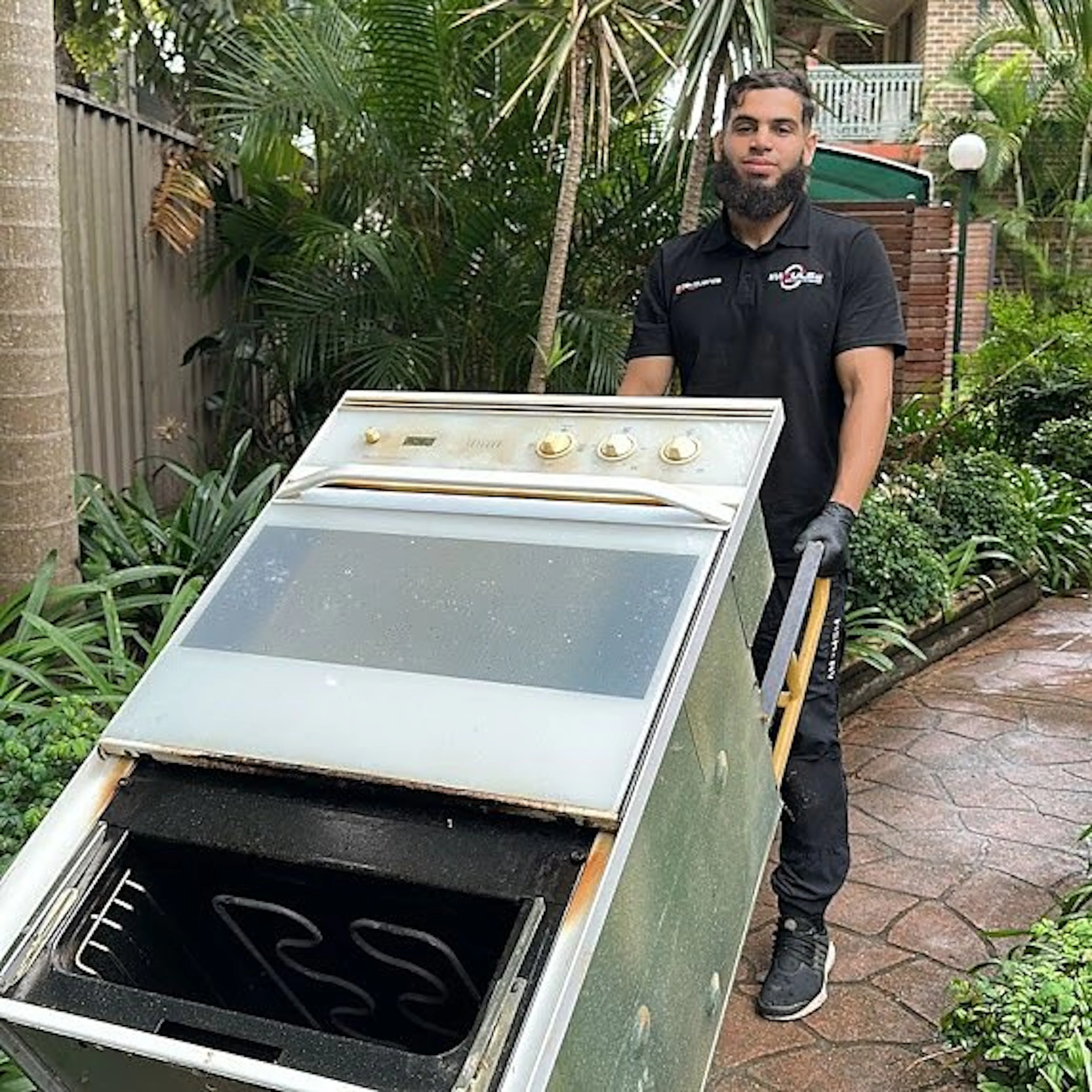 An Impulse Electrical Enterprise electrician removing an old oven