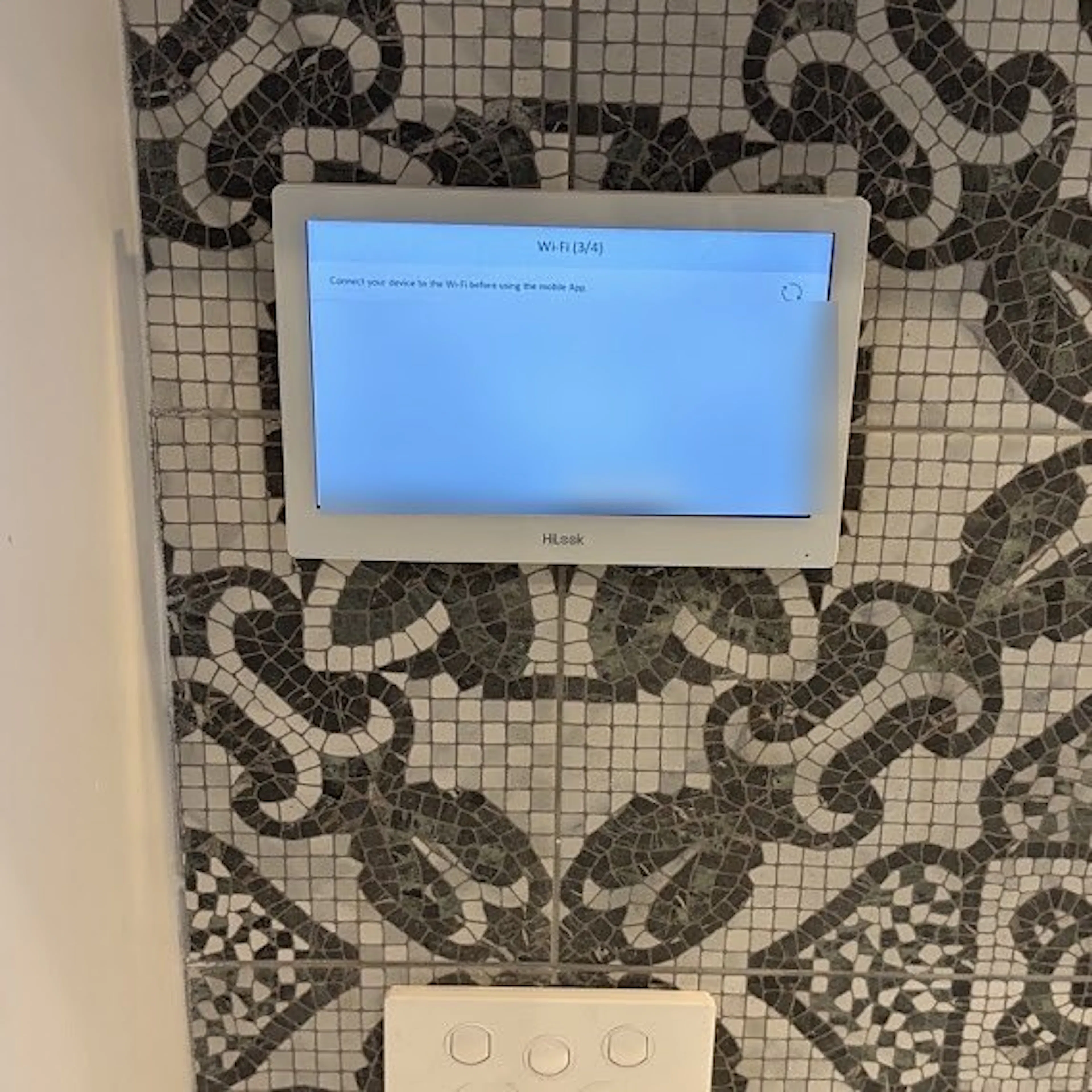7 inch indoor intercom monitor on a tiled wall, by Impulse Electrical Enterprise