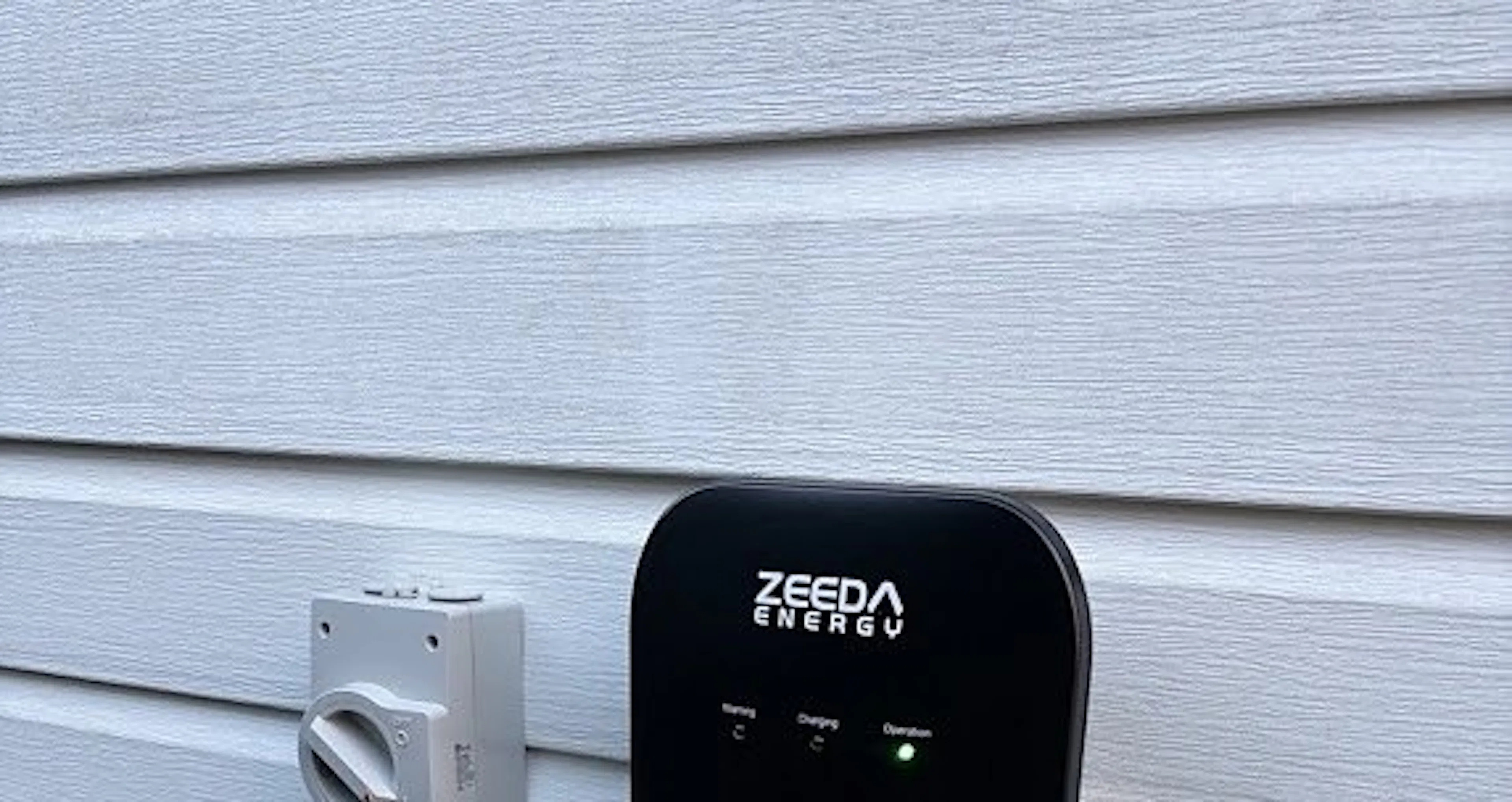 Single phase EV charger with an isolator on a weatherboard wall in Leichhardt, by Impulse Electrical Enterprise