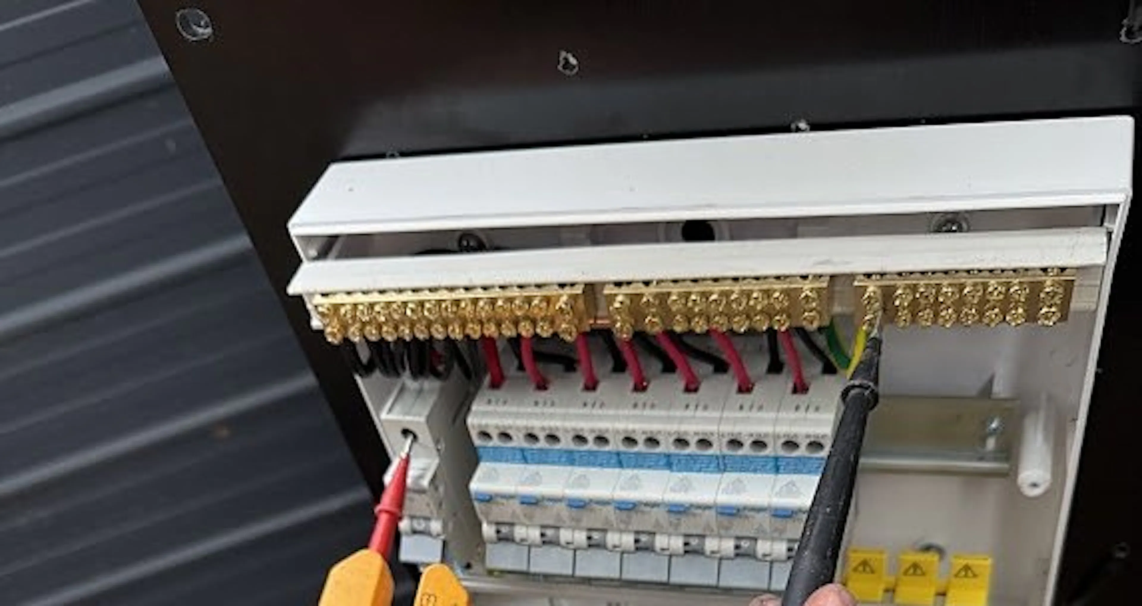 Electrician testing a new load centre in Putney, by Impulse Electrical Enterprise