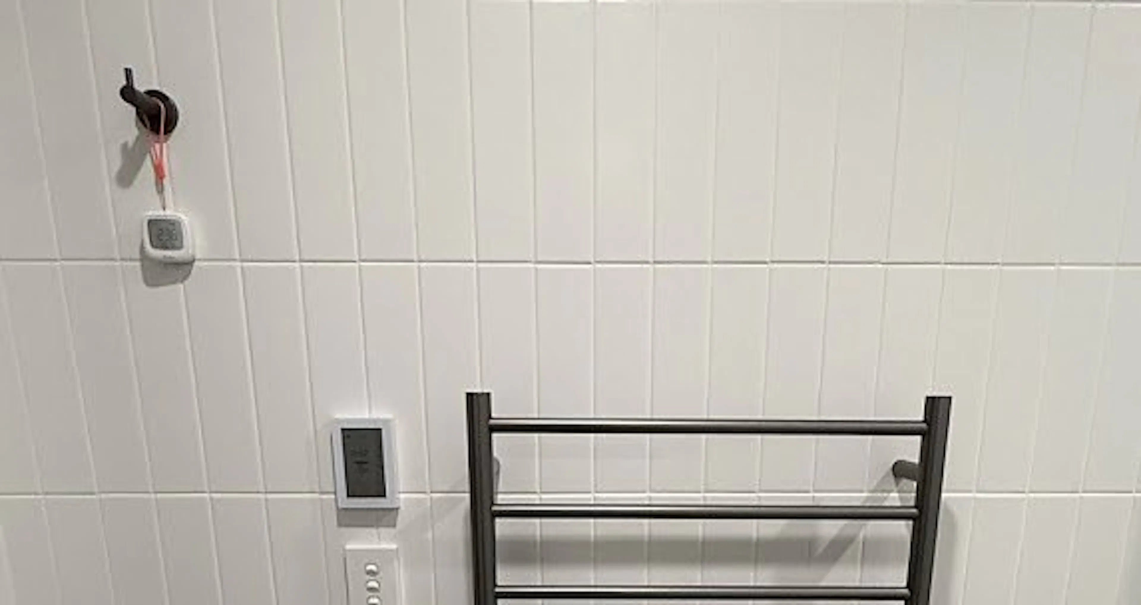 Heated towel rail with a timer panel in a North Strathfield bathroom, by Impulse Electrical Enterprise