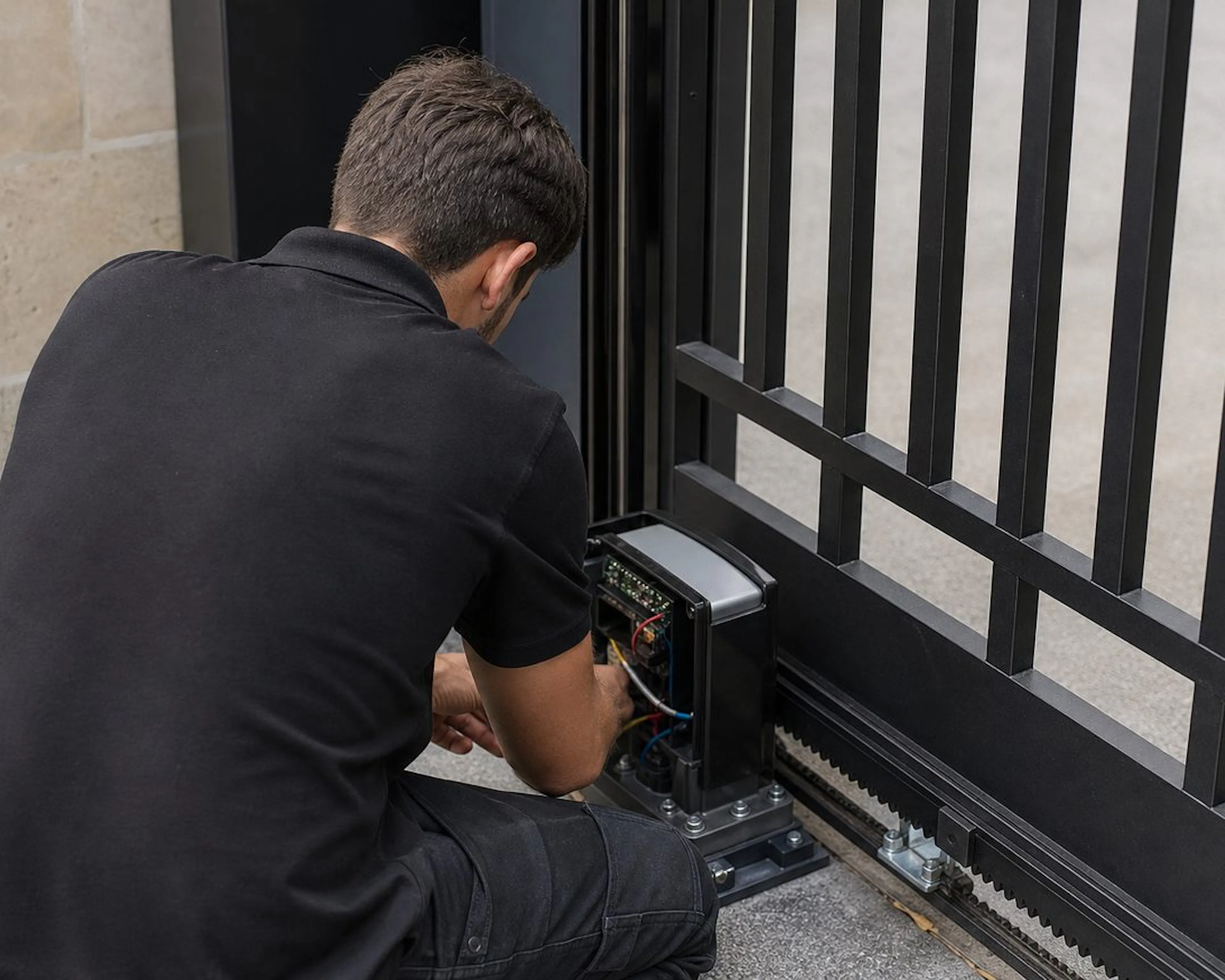 Electrician installing a sliding gate motor