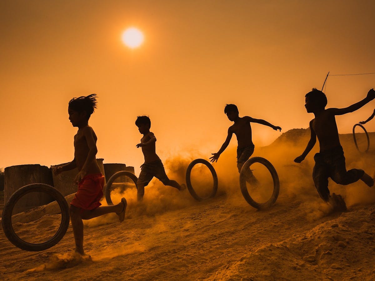 Children running down hill