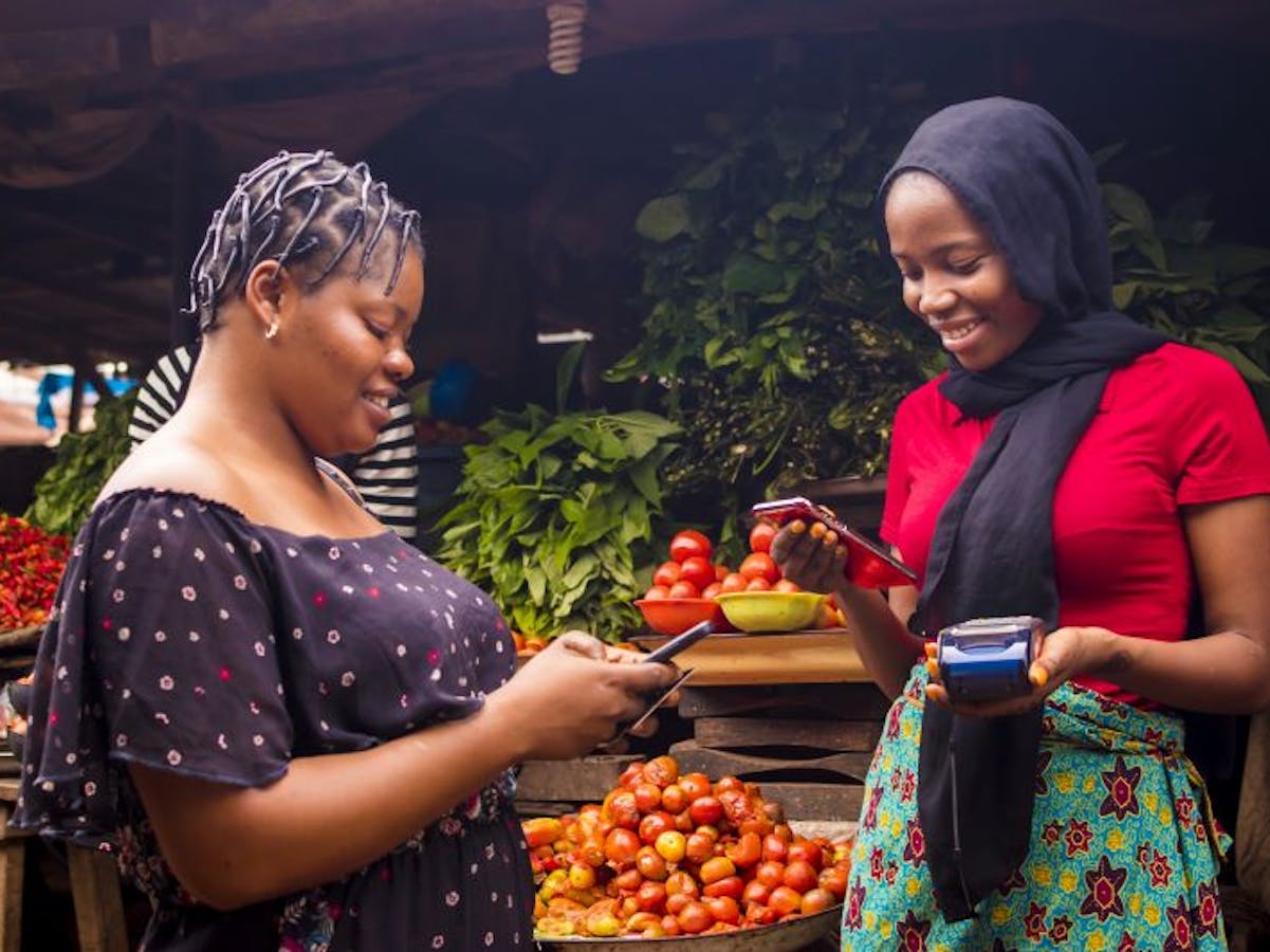 2 women using their phones