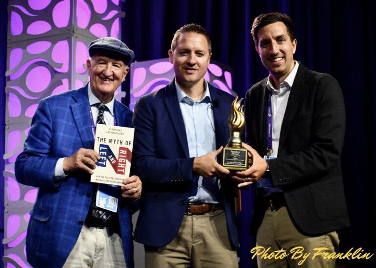 Verlan (right) with an award for his book