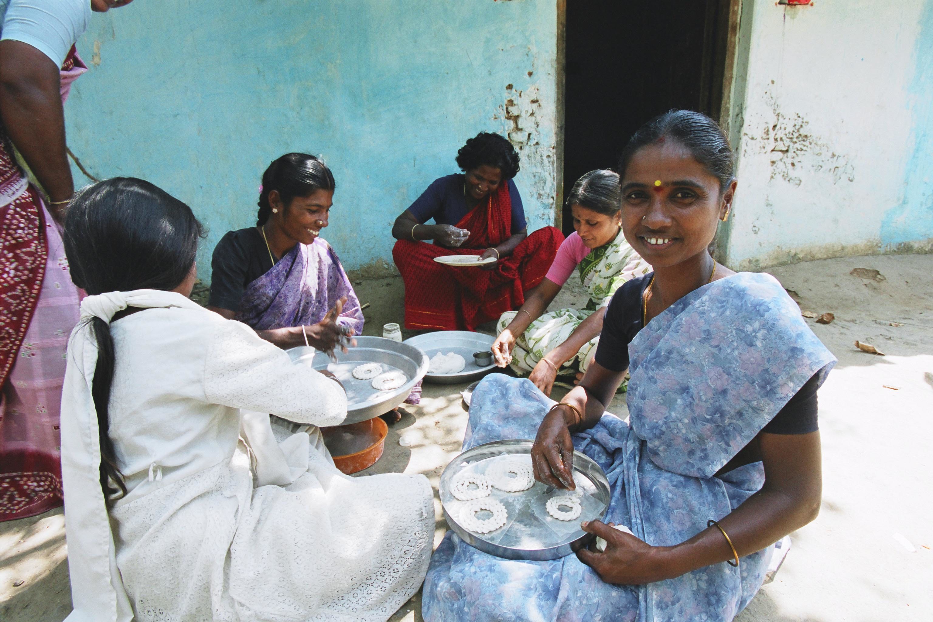 Women work on home-made production of biscuits.  They are part of a rural cooperative in Kesavarayanpettai, India.