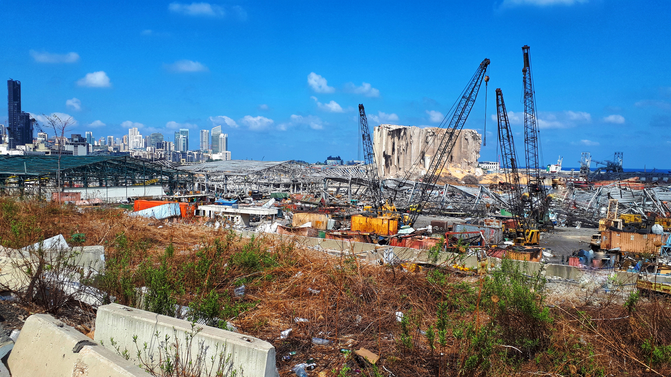 Mangled metal structures of buildings show the impact of the explosion at the Beirut port.