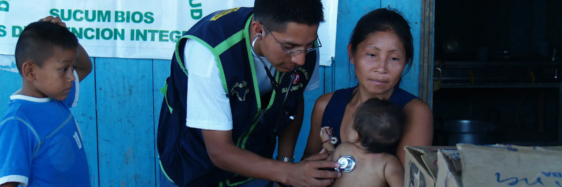 A medic examines a child at a riverside settlement in northern Ecuador.