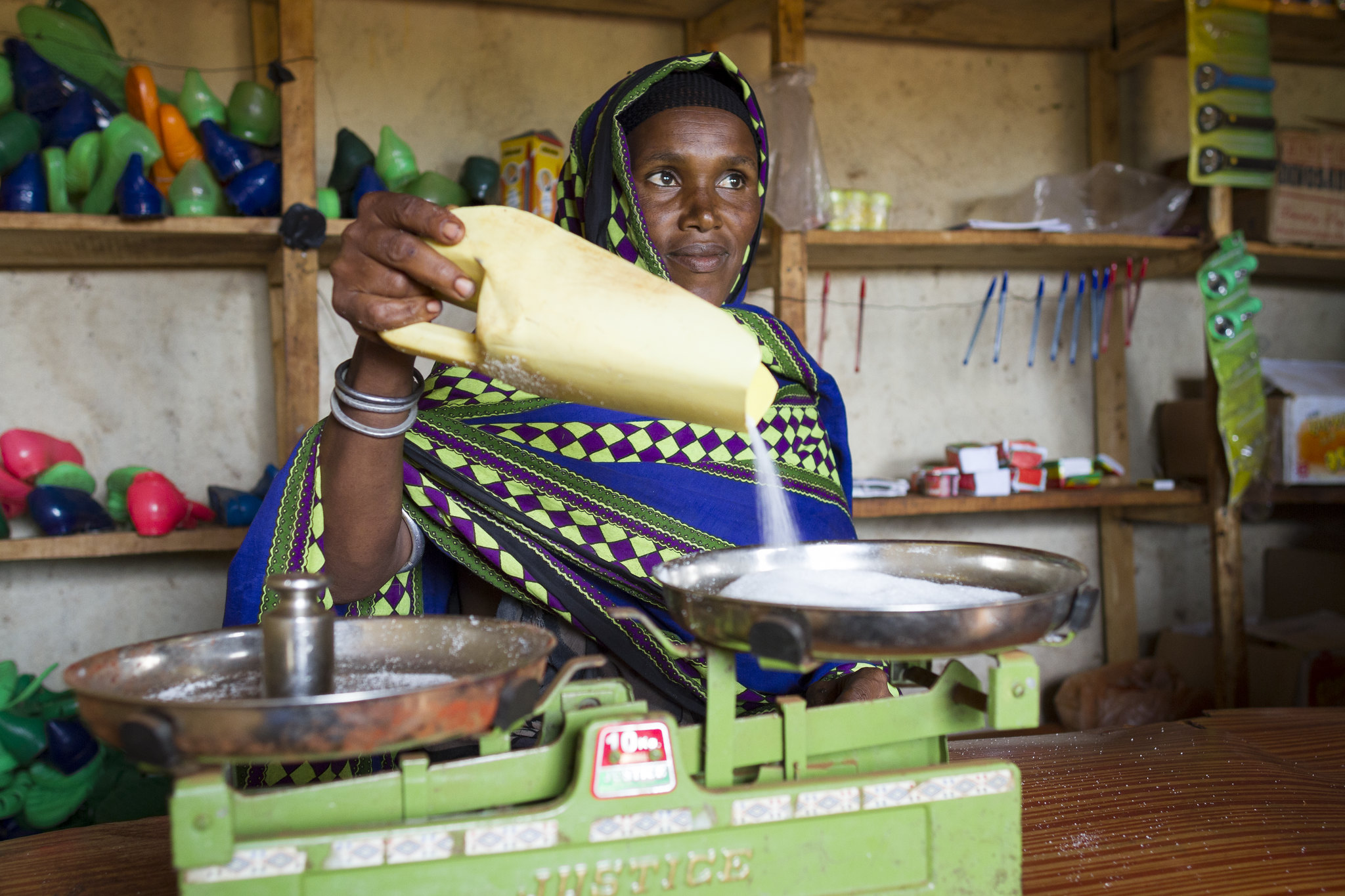A woman worker looks after her cereal group’s small shop in Ethiopia