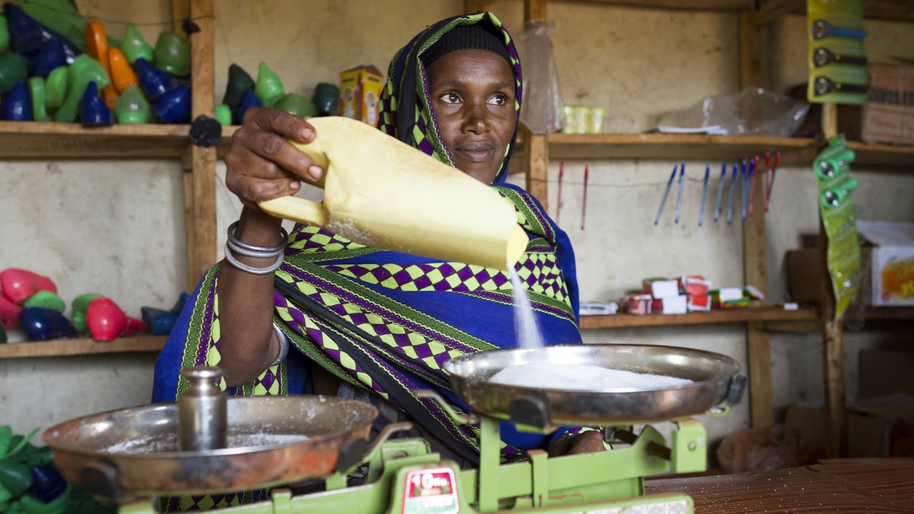 A woman worker looks after her cereal group’s small shop in Ethiopia