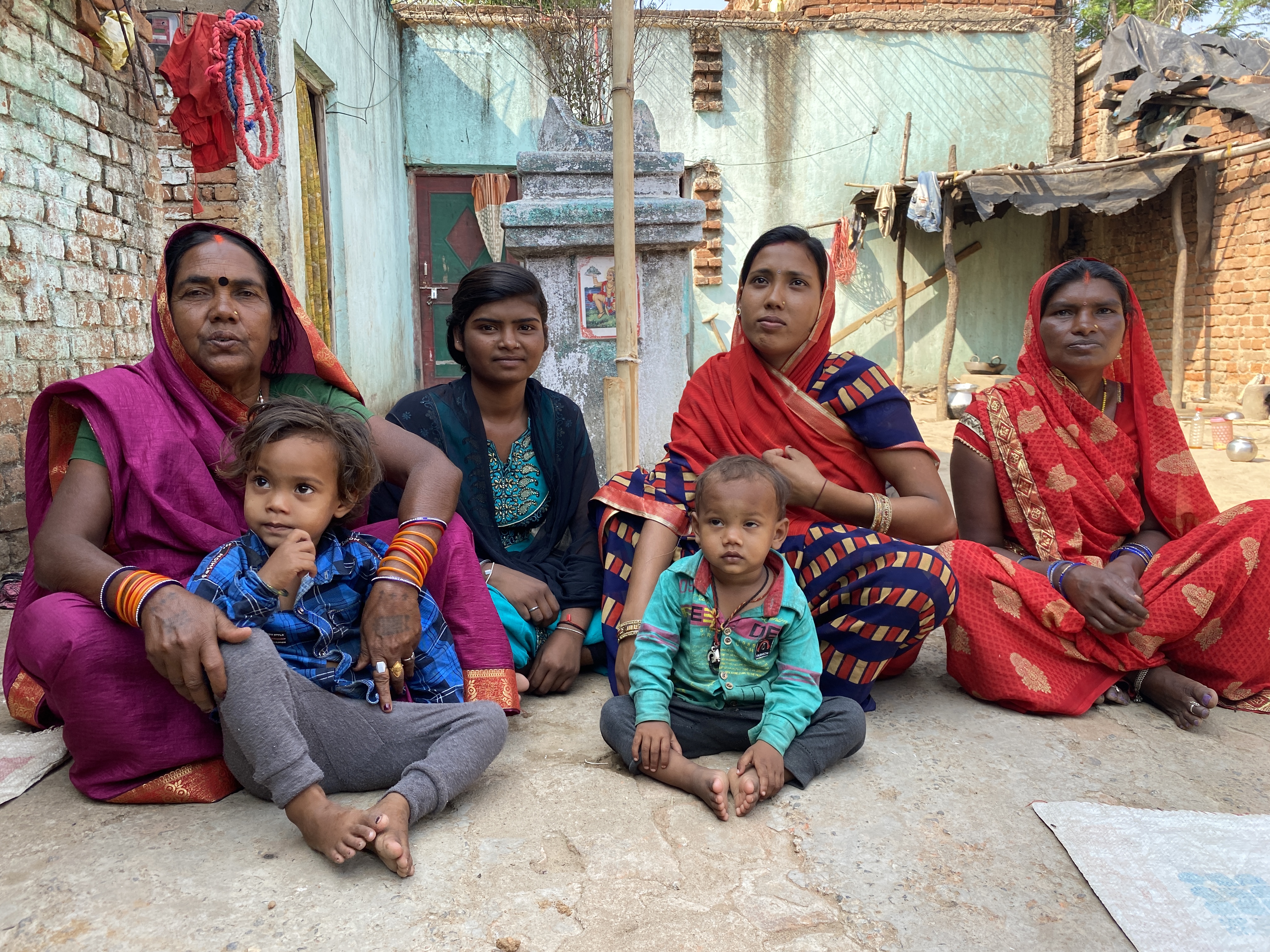 Suman Kumari is seated outside with other member of her family including three women and two little children. 
