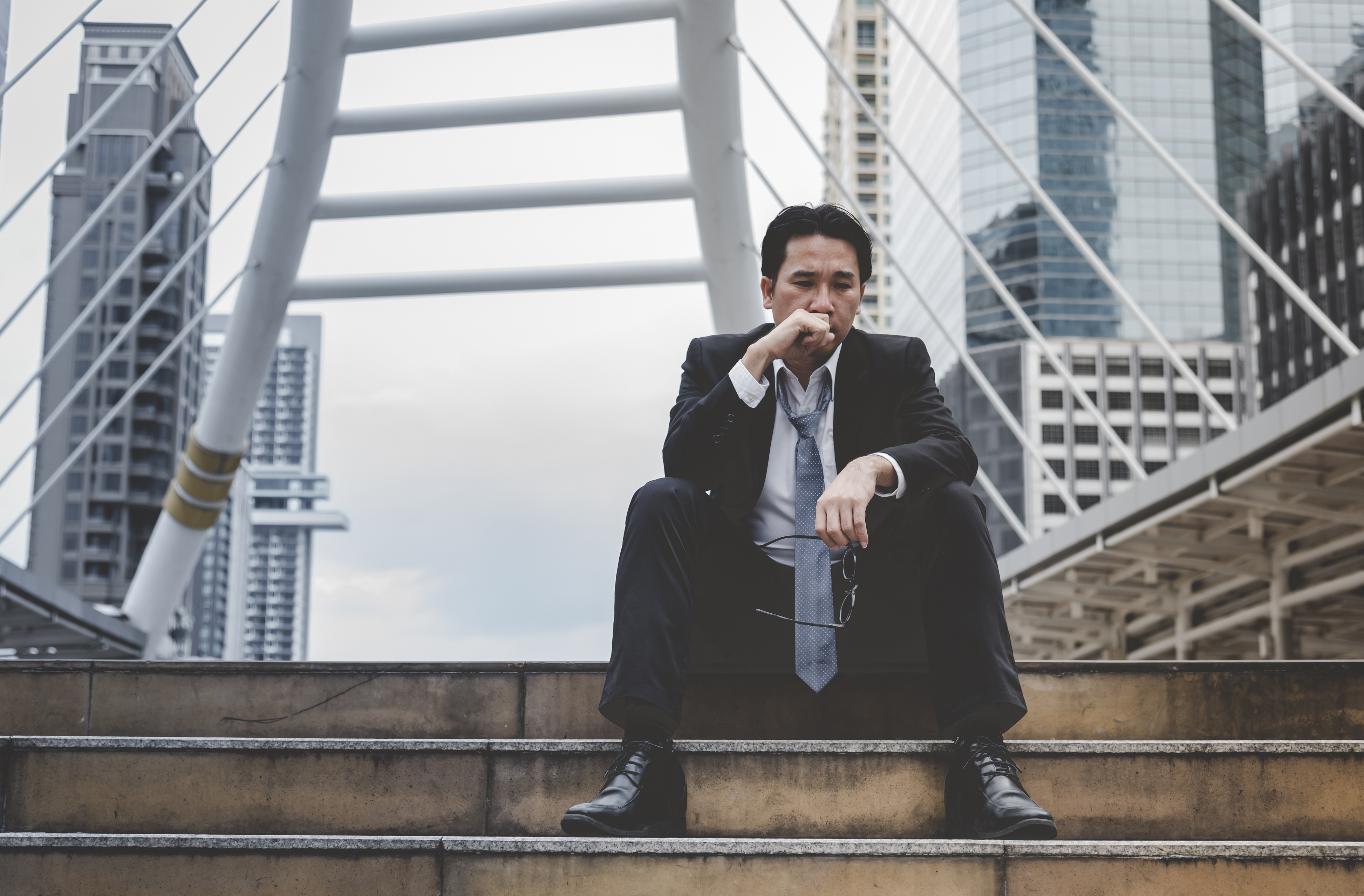 Asian businessman feeling sad and lonely