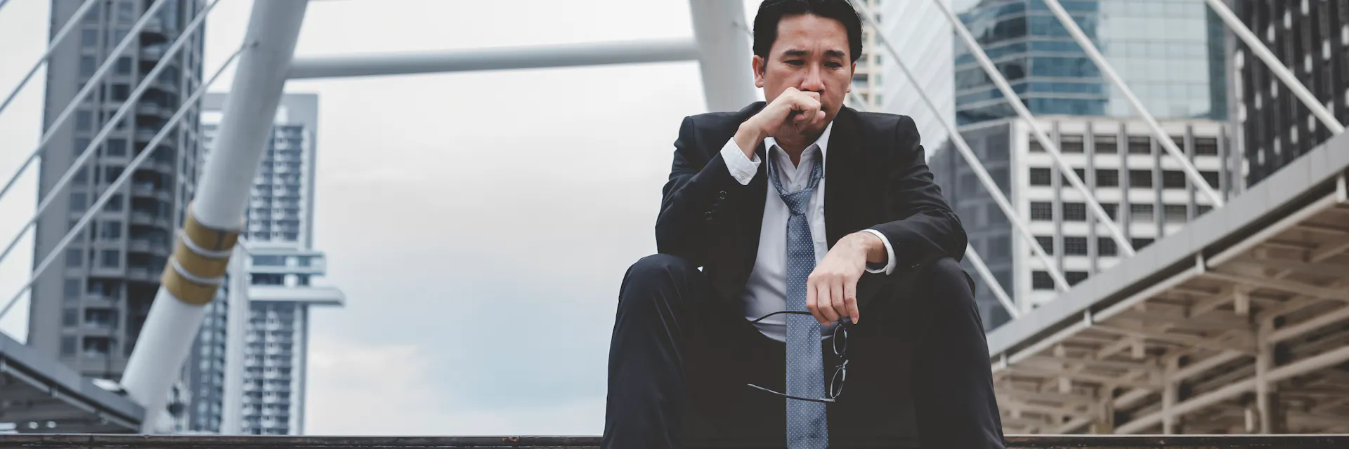 Asian businessman feeling sad and lonely