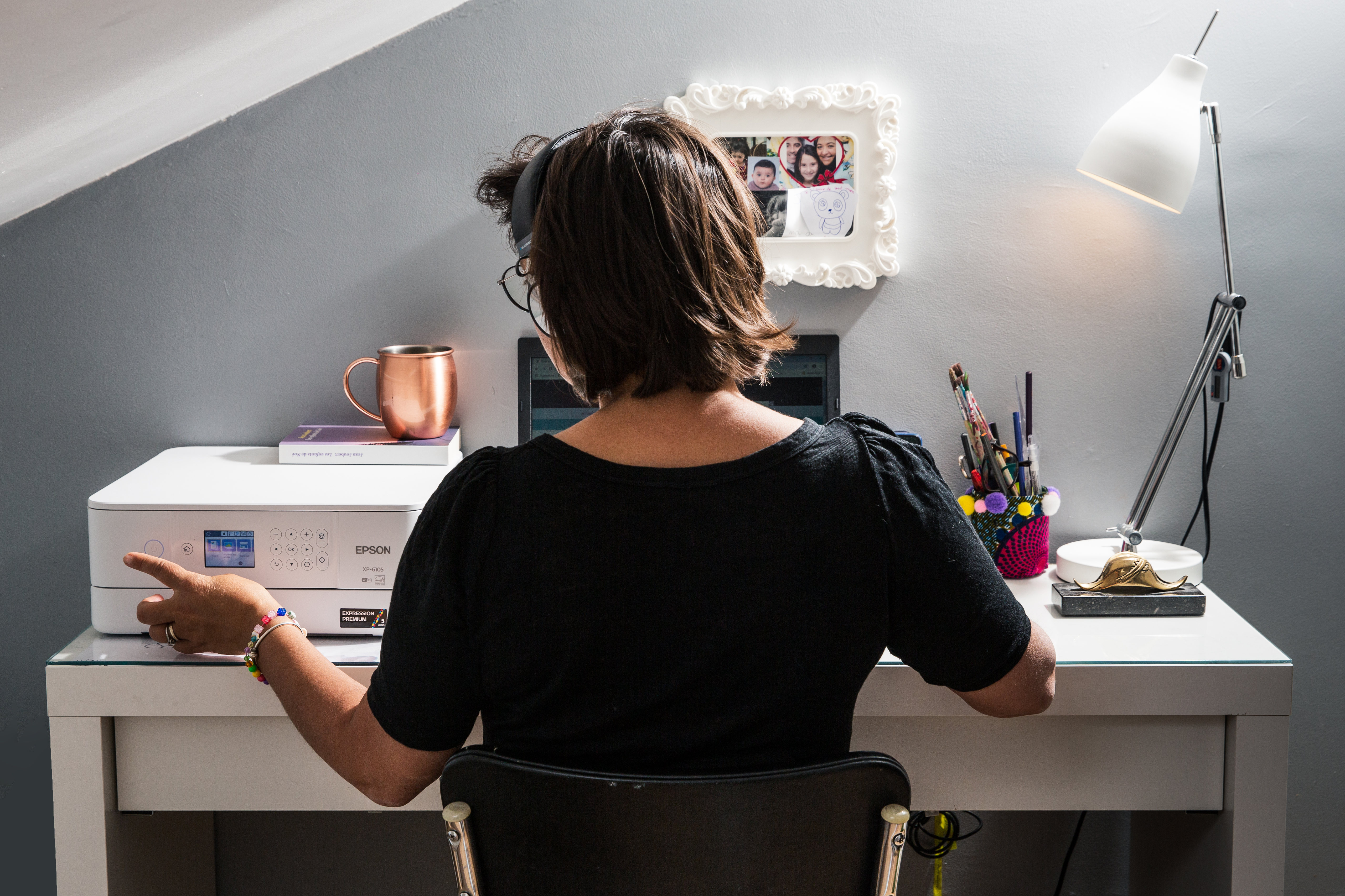 Woman teleworks at desk. 