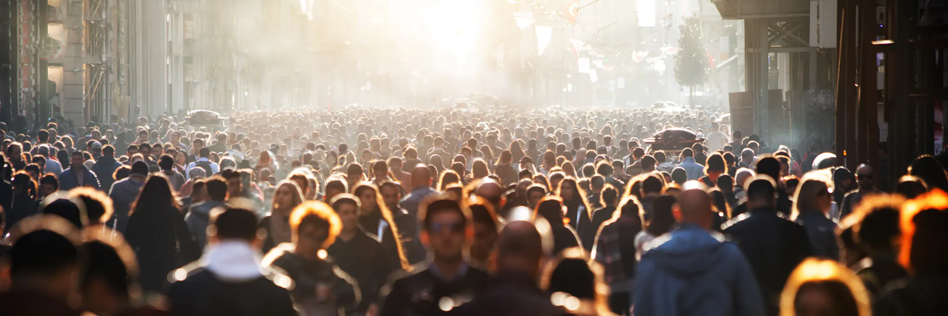 A city street packed with hundreds of people on a sunny day in Thailand. (2020)