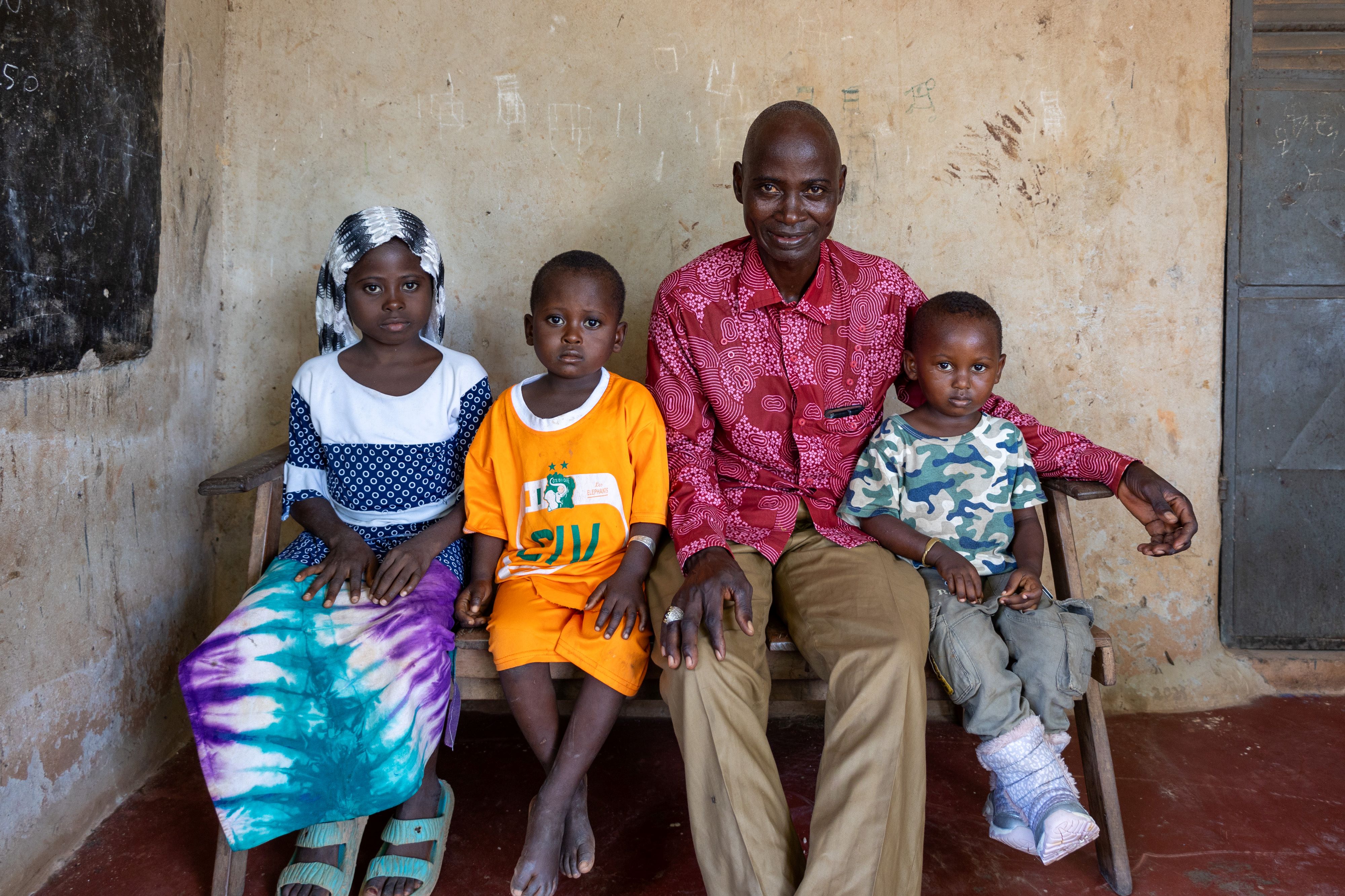 Yabao Oubarou sits with his three young children. (2024).