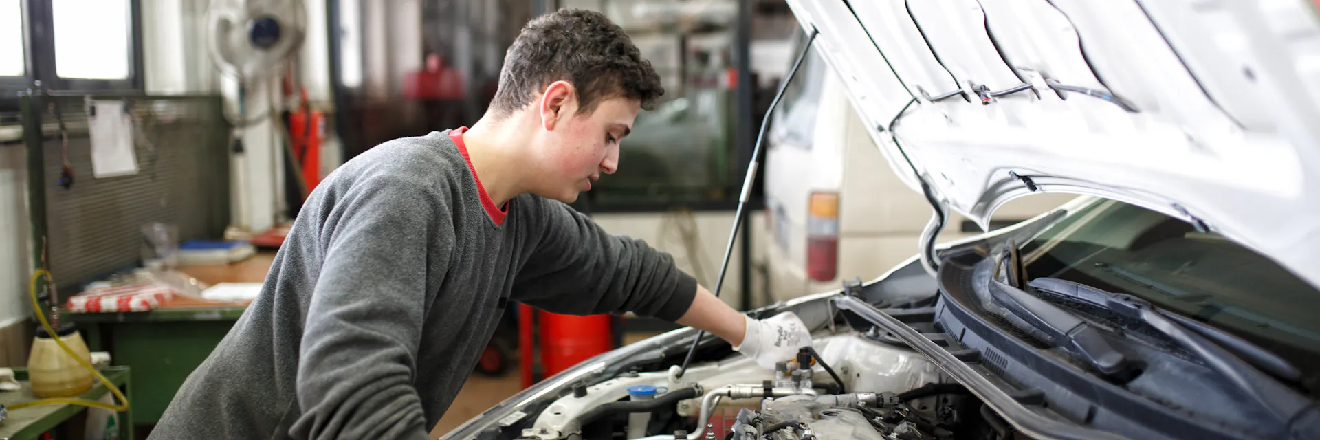 A young man Alaaddin examines a problem in a car engine. 2019/02/28 Türkiye