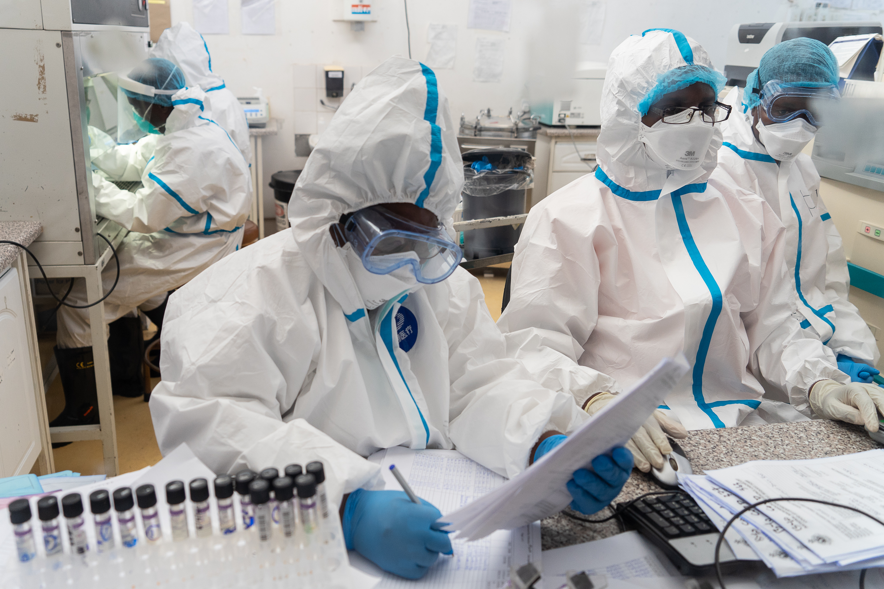 Health workers wear protective clothing and personal protective equipment at the Mpilo Central Hospital COVID-19 testing laboratory in ZImbabwe.