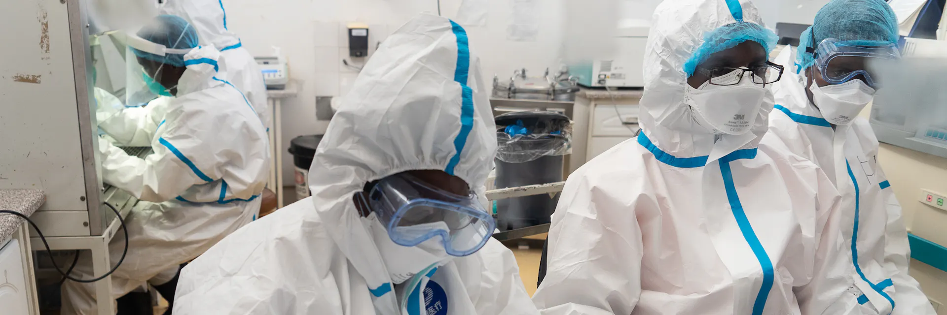 Health workers wear protective clothing and personal protective equipment at the Mpilo Central Hospital COVID-19 testing laboratory in ZImbabwe.