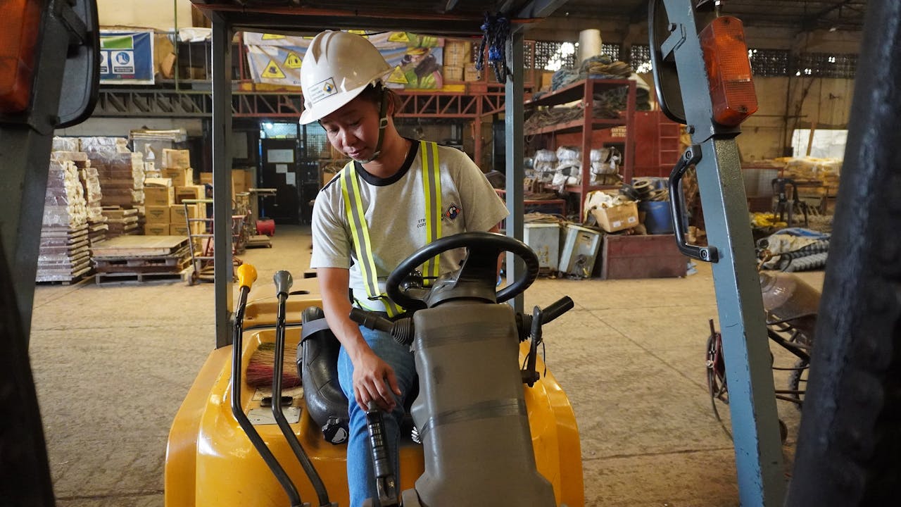 Myrna Pitaluna-Alngog operates a forklift in a construction warehouse. 