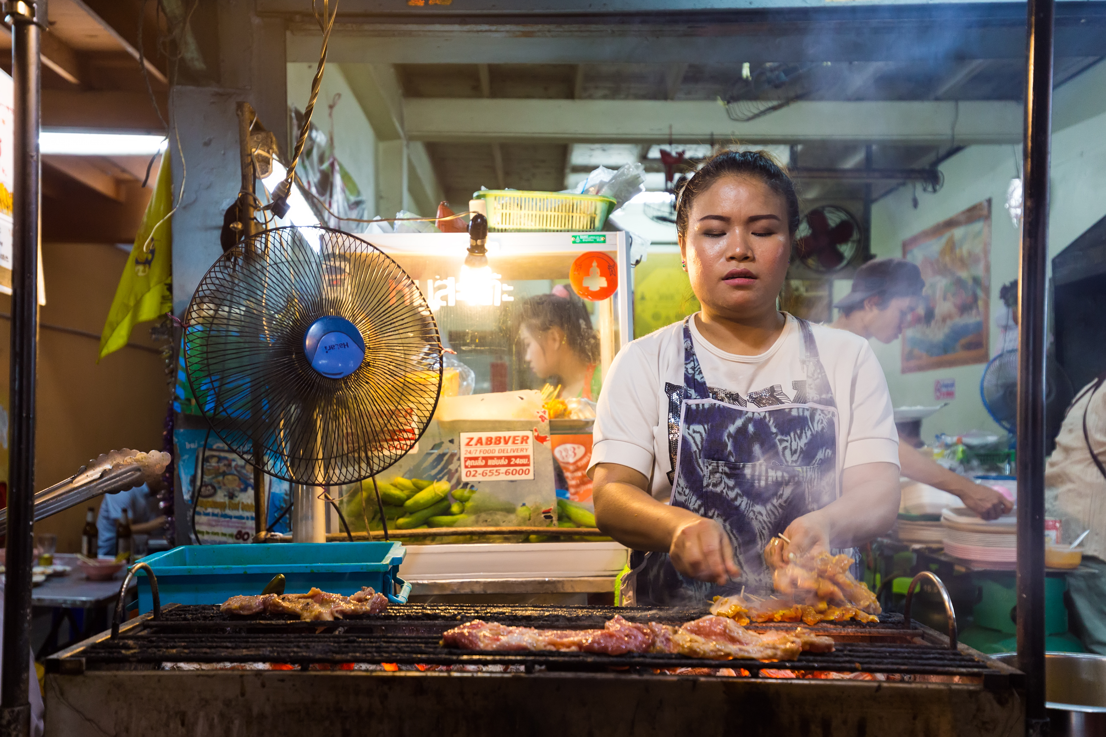 A woman is roasting meat.
