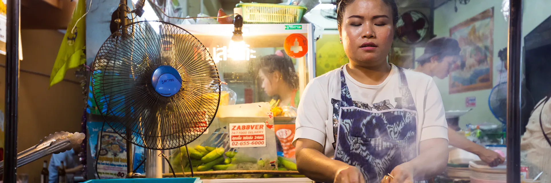 A woman is roasting meat.