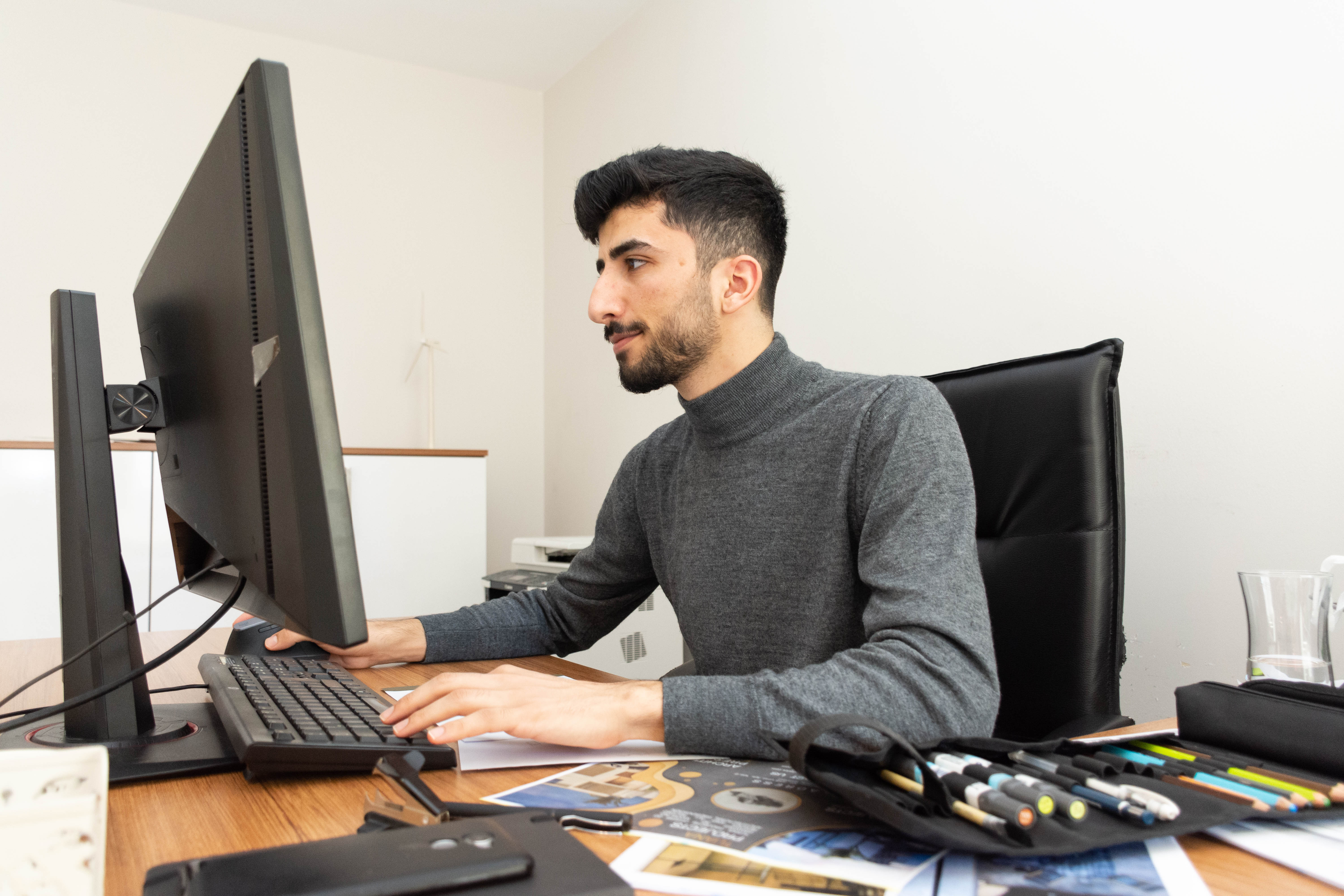 Morshed works at his desk, the first time as a formally employed architect.  