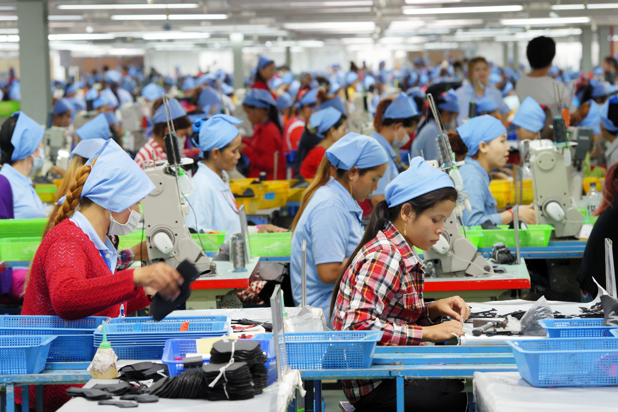 Cambodian workers at work in a local footwear manufacturing plant. 
