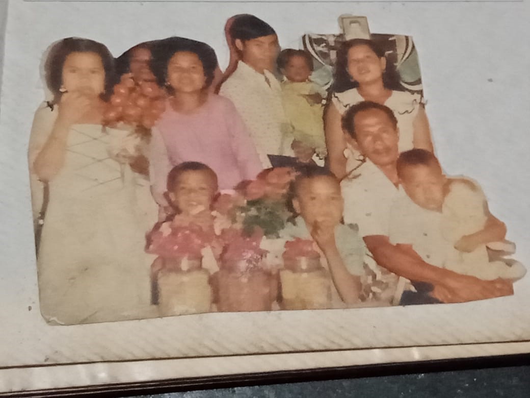 A family snapshot when Echi was little.  She appears in the bottom right of the photo and is holding a doll.
