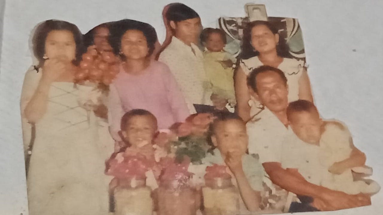 A family snapshot when Echi was little.  She appears in the bottom right of the photo and is holding a doll.