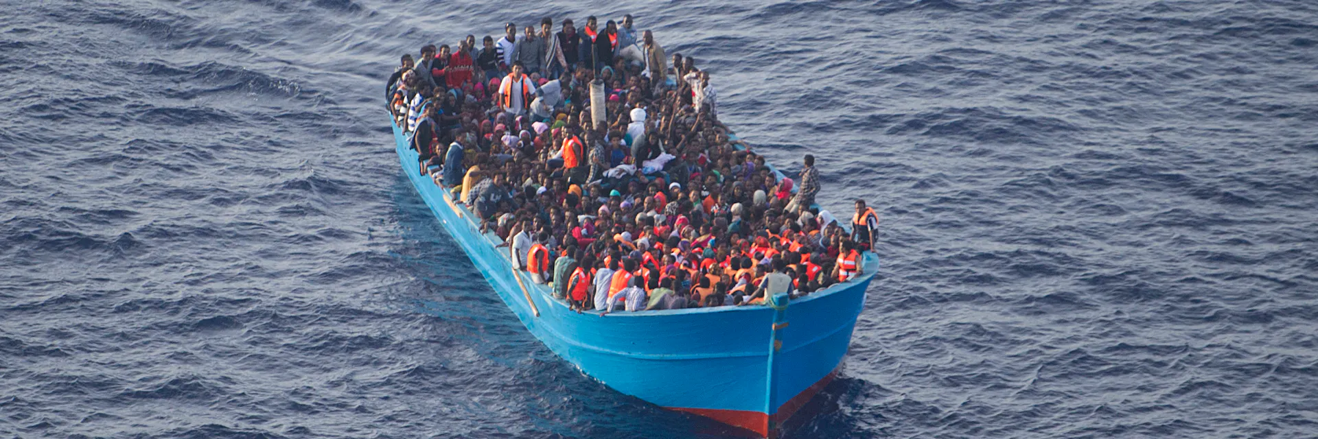 Migrant boat full of people at sea. Photo taken from plane during rescue operation of the Ministry of Defense of Spain. October 4, 2016