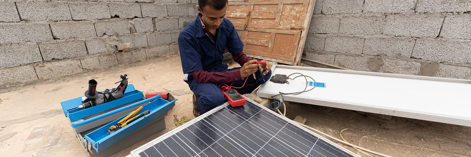 Muhammed Ali Mohsen, 26, installs a solar panel in the Abyan Governorate in Yemen where he works as a solar power technician.