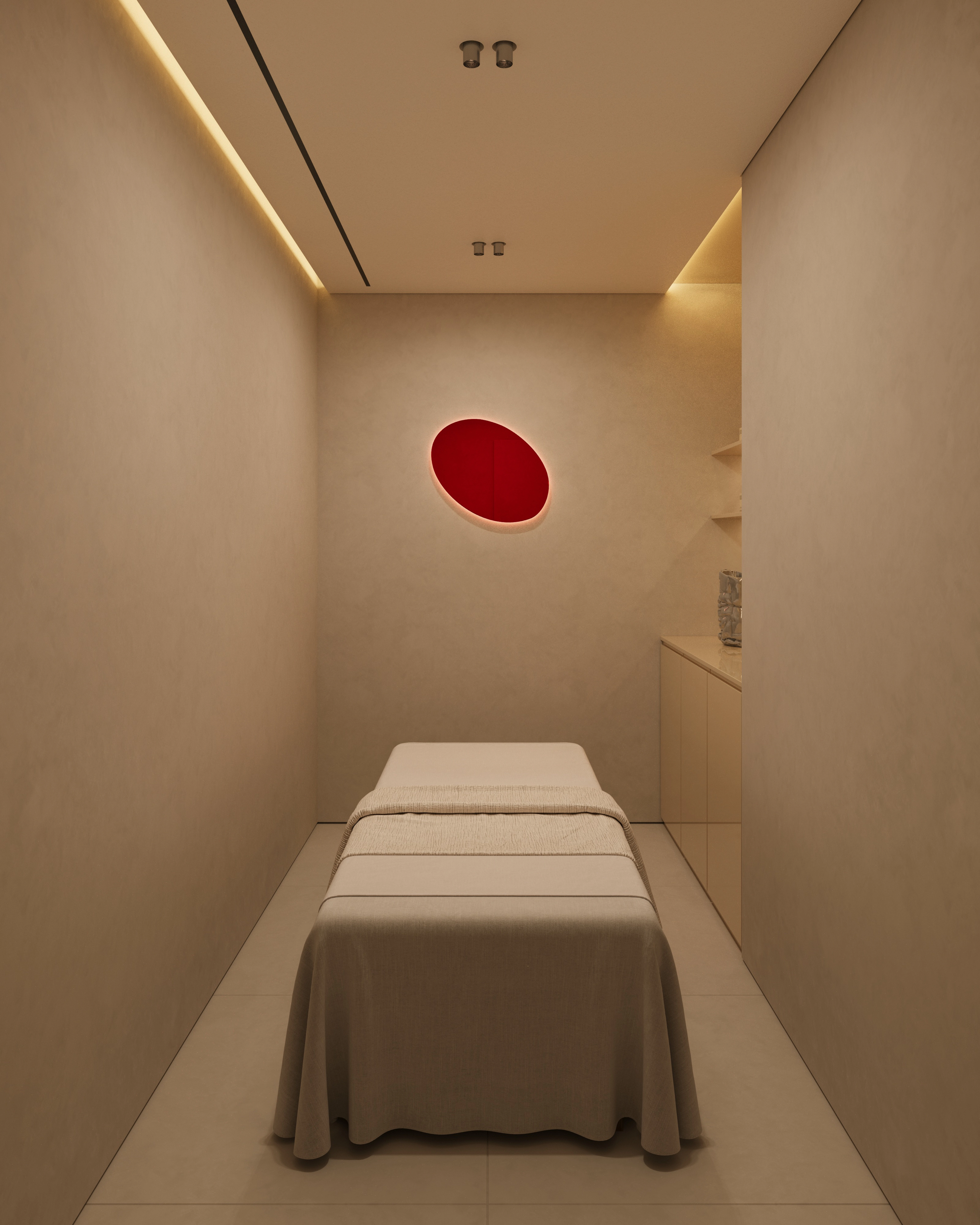Minimal nail salon treatment room with a white treatment bed, beige walls, recessed lighting, and a red oval wall accent.