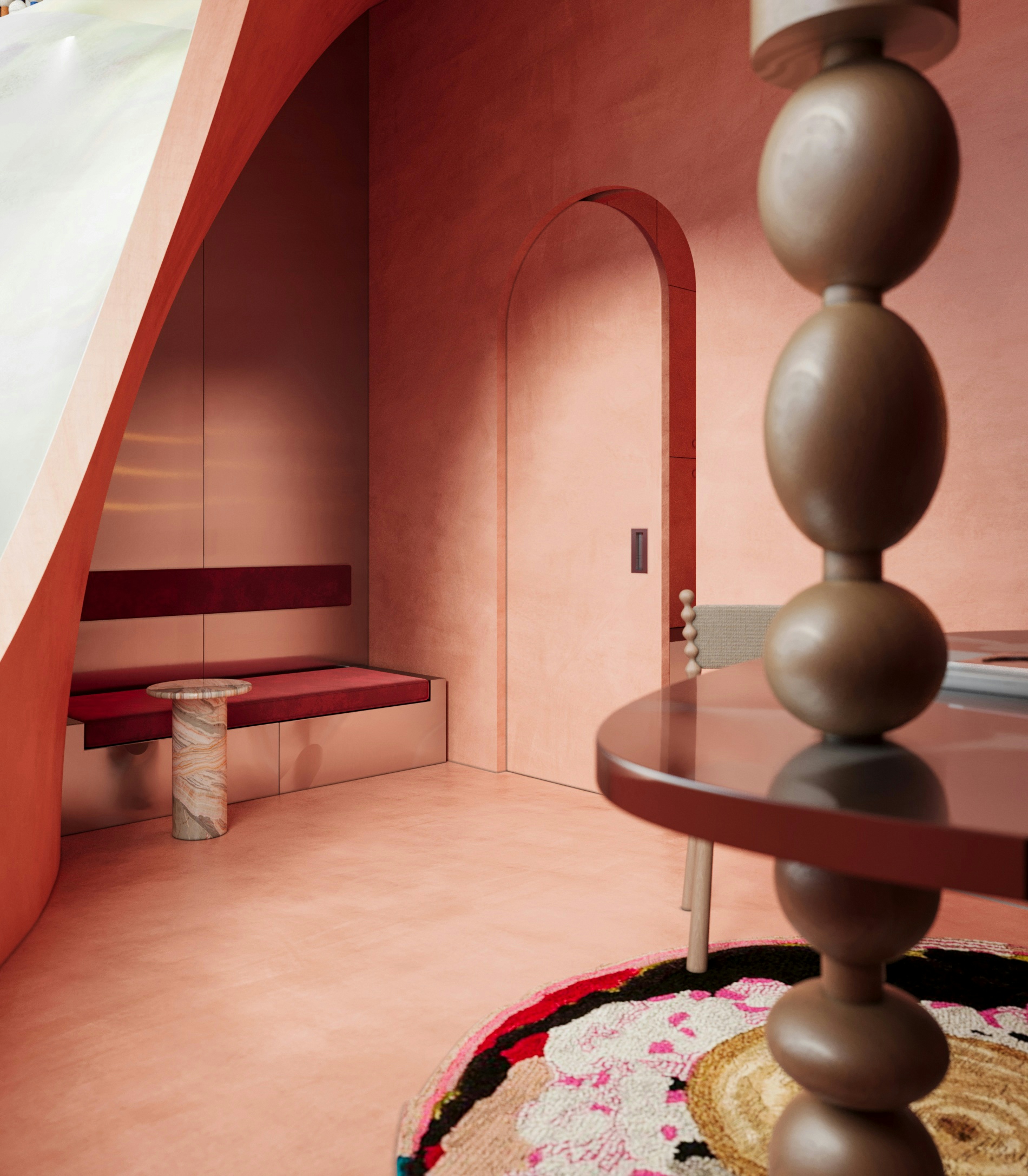 Contemporary office interior with coral-toned walls, arched doorway, custom seating, and artistic round rug