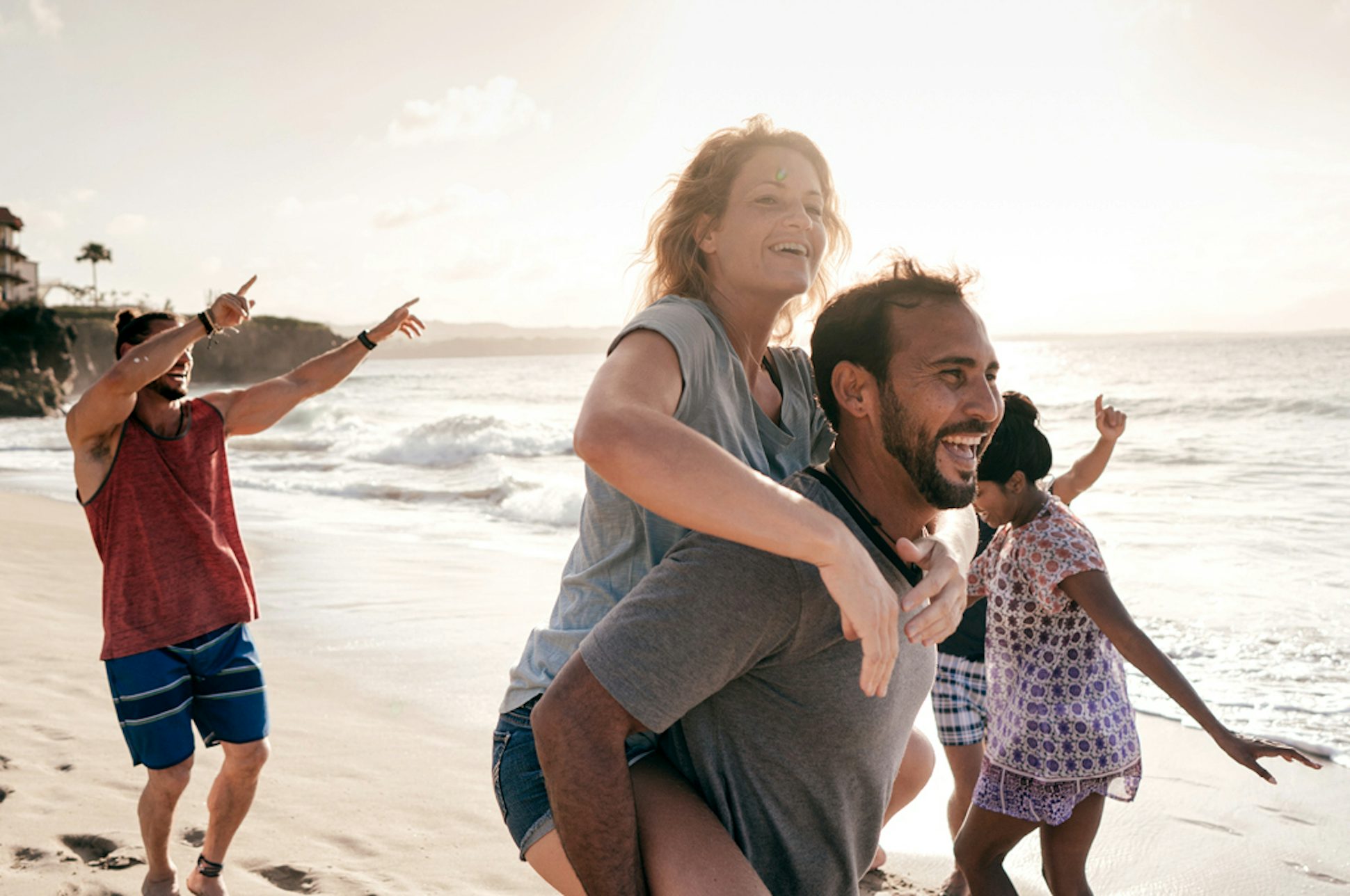Family frolicking on a beach