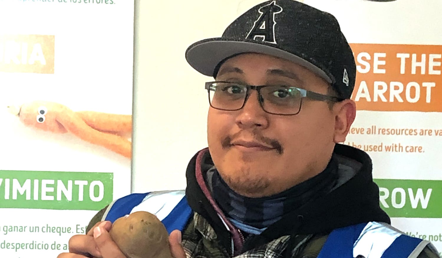 Aurelio holding up a potato.