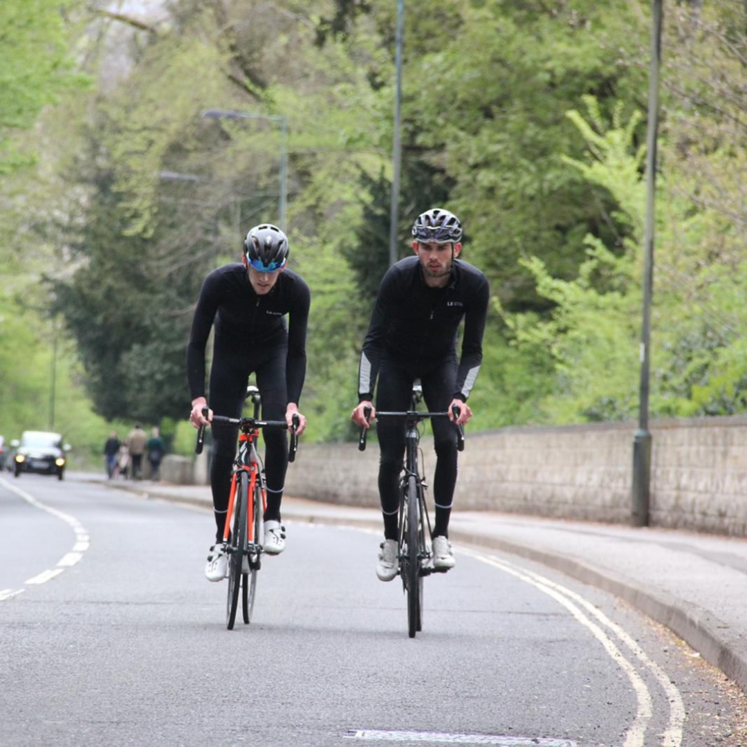 Conor and Nic cycling up hill during their challenge