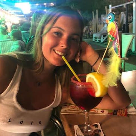 Charlotte drinking a cocktail