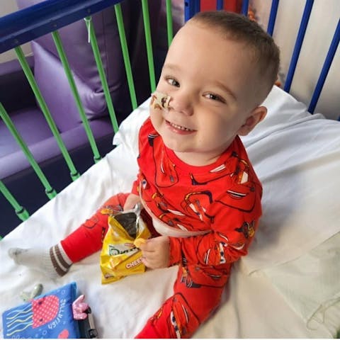Frank smiling in his hospital cot bed