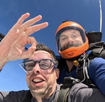 Steve with his parachute and his instructor